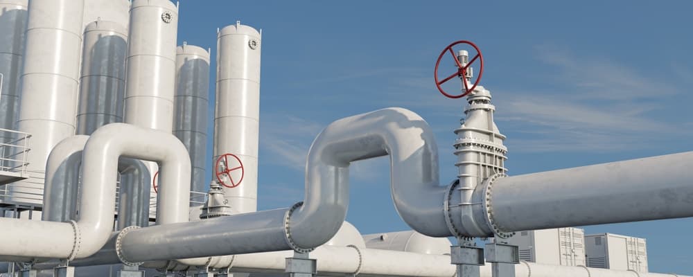 Technician checking industrial HVAC equipment with gauges